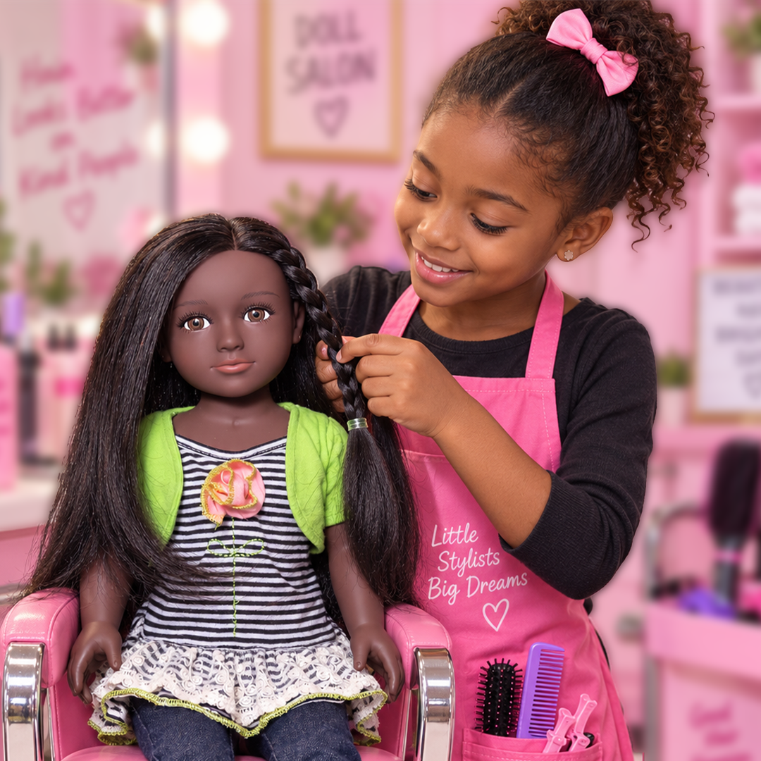A child braiding a My Salon Doll’s real hair